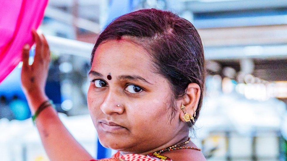 Factory, Worker, Textile Industry - A factory worker standing below the textile yarn and looking at the camera