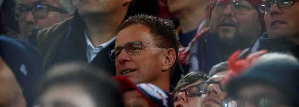 RB Leipzig sports director Ralf Rangnick (C) watches the Dortmund match among Leipzig fans on 4 Feb