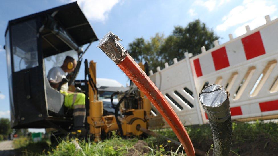 A worker drills runs for broadband tubing in a German village in this file photo