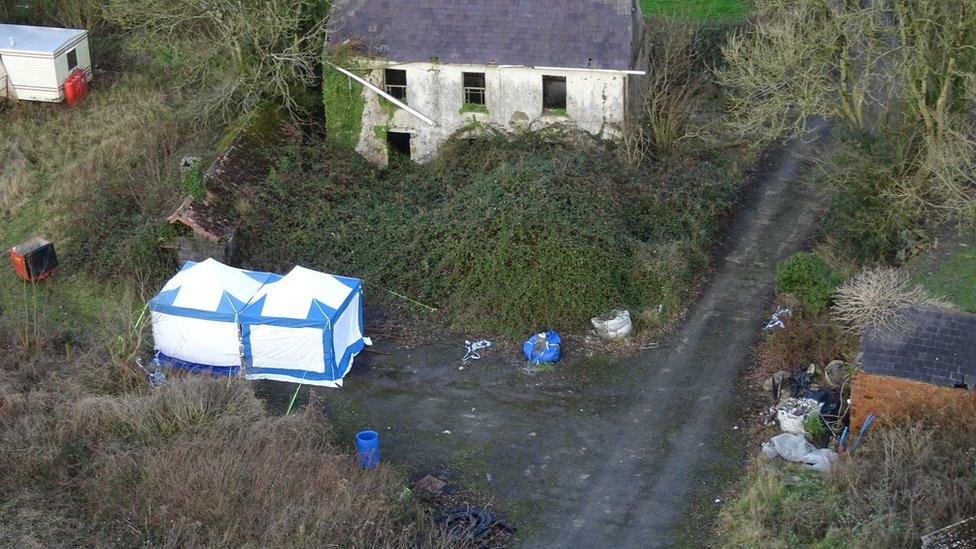 Forensic tents at the back of a dilapidated old house at Cincoed Farm