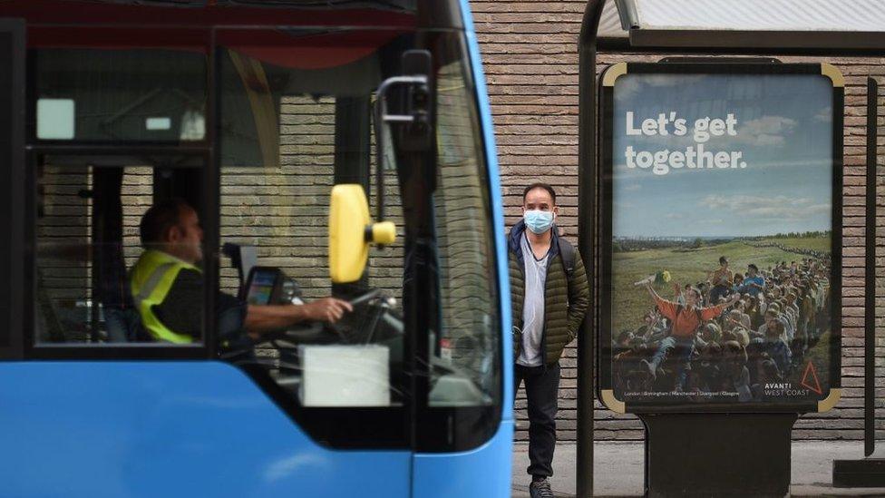 Man waits for bus in Manchester