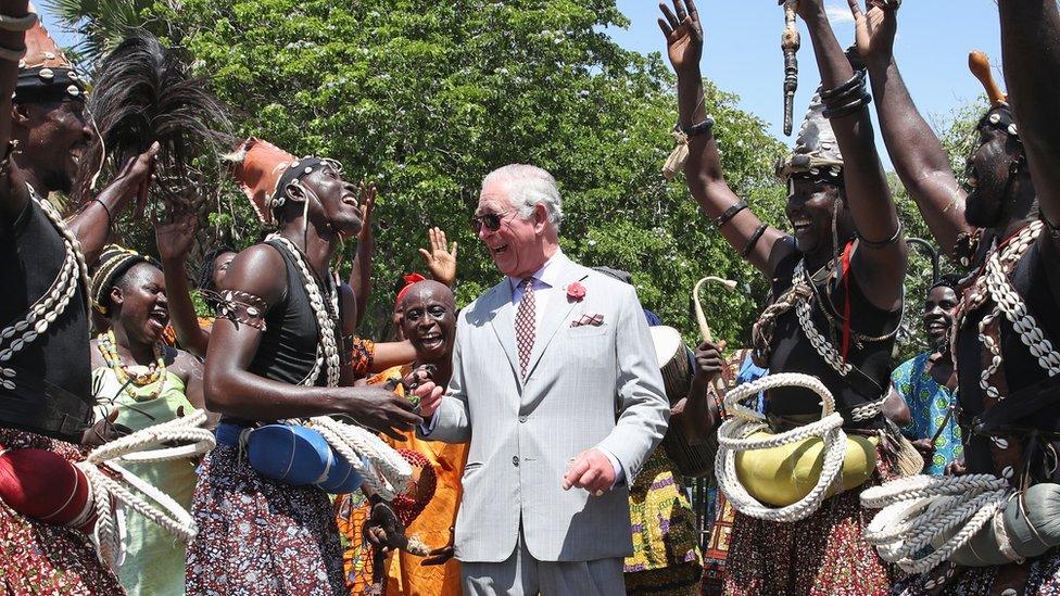 Prince Charles, Prince of Wales is greeted by traditional dancers during a tour of Christiansborg Castle on November 3, 2018 in Accra, Ghana