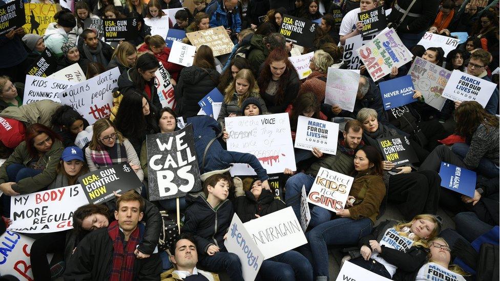 Supporters of stricter gun control stage a "die in" during a solidarity rally with "March For Our Lives" outside the U.S. Embassy in London, Britain