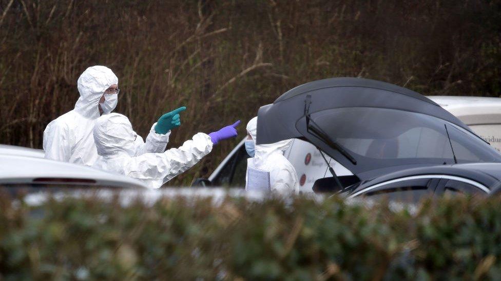 Forensics officers at John Caldwell's car the day after he was shot