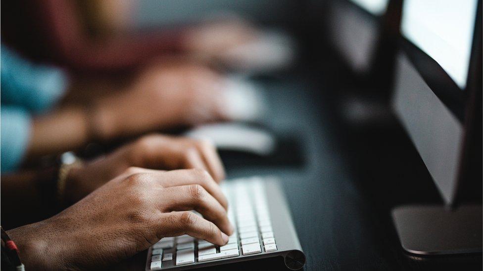 Pupils with their hands on keyboards