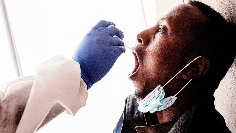 A nurse from Lancet Nectare hospital (L) performs a COVID-19 coronavirus test in Richmond, Johannesburg, on December 18, 2020.