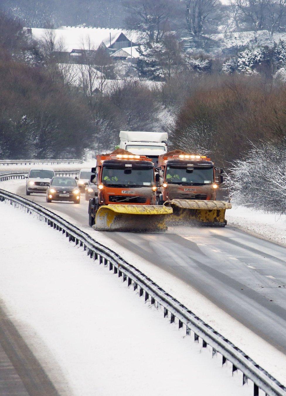 Snowploughs seen on clearing a snow-covered.