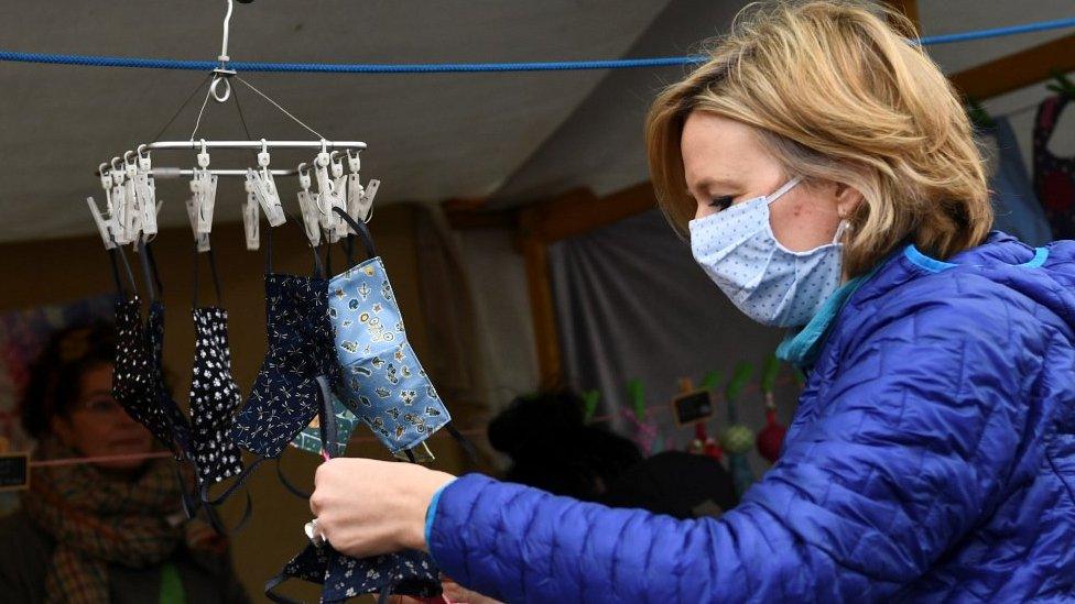 Woman buying masks at a Berlin market, 25 Apr 20