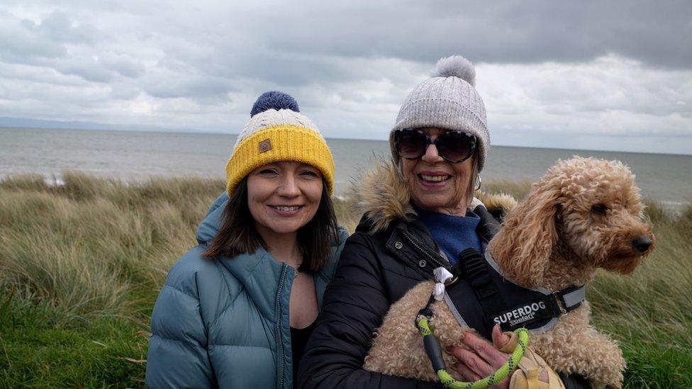 Lois Owens with a woman and a dog