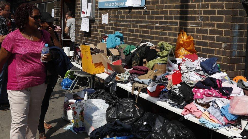 People look at the clothes donated outside a rescue centre