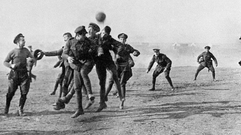 Soldiers enjoying a game of football in 1915