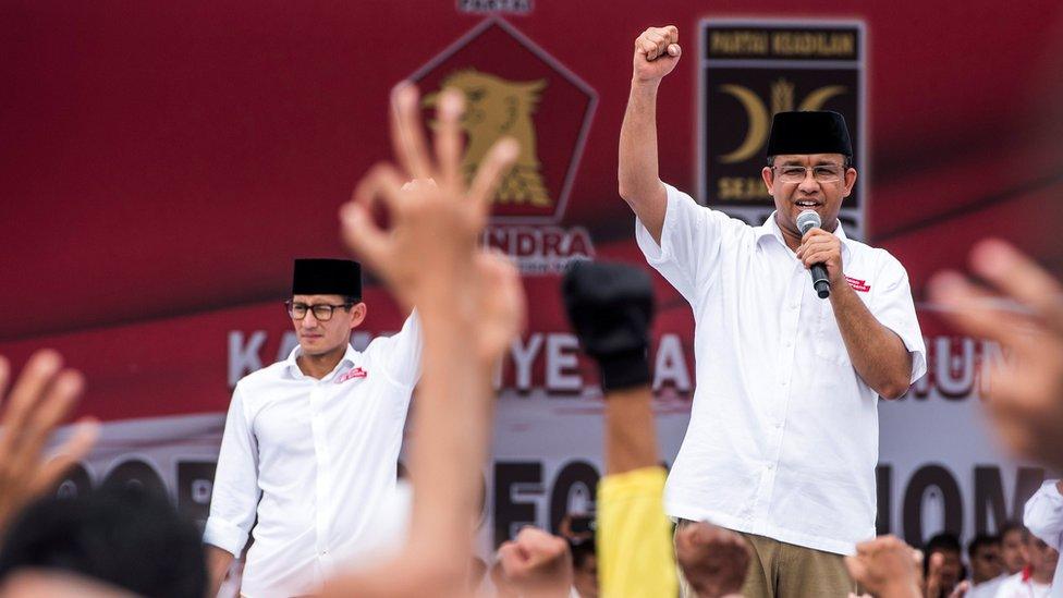 Anies Baswedan (right), a candidate in the running to lead the Indonesian capital Jakarta, and his deputy Sandiaga Uno stand in front of their supporters during campaigning in Jakarta, Indonesia, February 5, 2017.