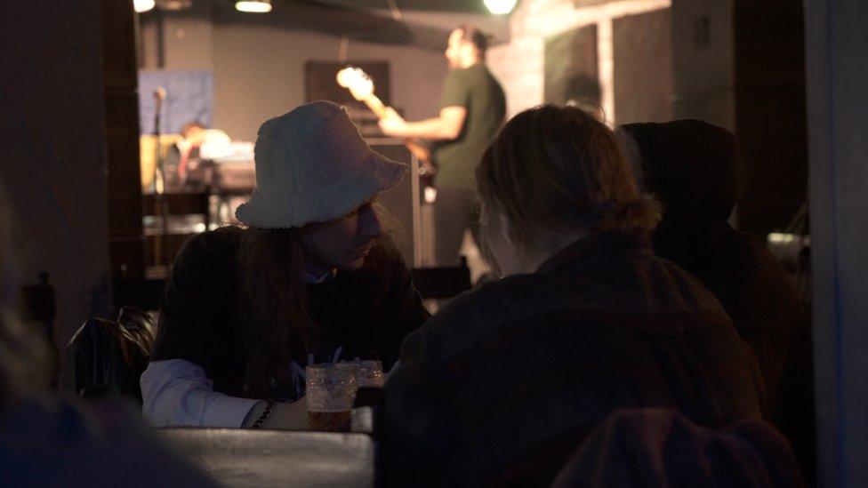 Two customers enjoy a drink in a local bar in Odesa