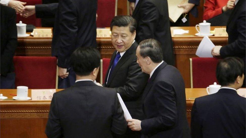 Wang Qishan (centre R), China"s Politburo Standing Committee member and head of China"s anti-corruption watchdog, talks to President Xi Jinping (centre L) as they leave after the opening session of the Chinese People"s Political Consultative Conference (CPPCC) at the Great Hall of the People in Beijing, China, March 3,