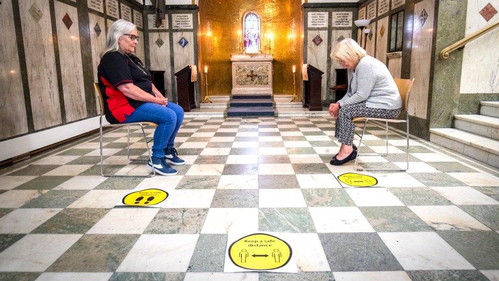 Parishioners Jacqueline Baillie and Linda Farrer pray in the Memorial Chapel at St Cuthbert's, which is now open for private prayer