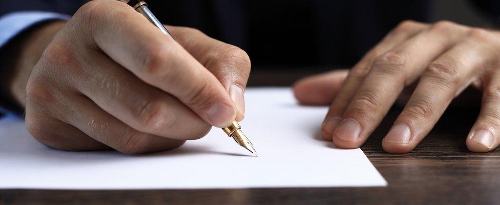 Man signing document