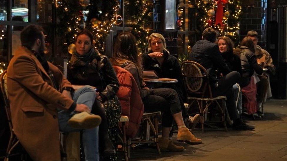 People sat outside at a restaurant in Soho