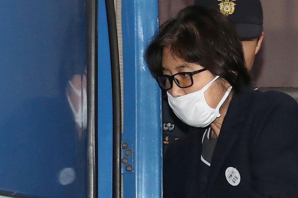 This picture taken on 19 November 2016 shows Choi Soon-sil, the woman at the heart of a lurid political scandal engulfing South Korea's President Park Geun-Hye, being escorted after questioning at the Seoul Central District Prosecutors" Office in Seoul.