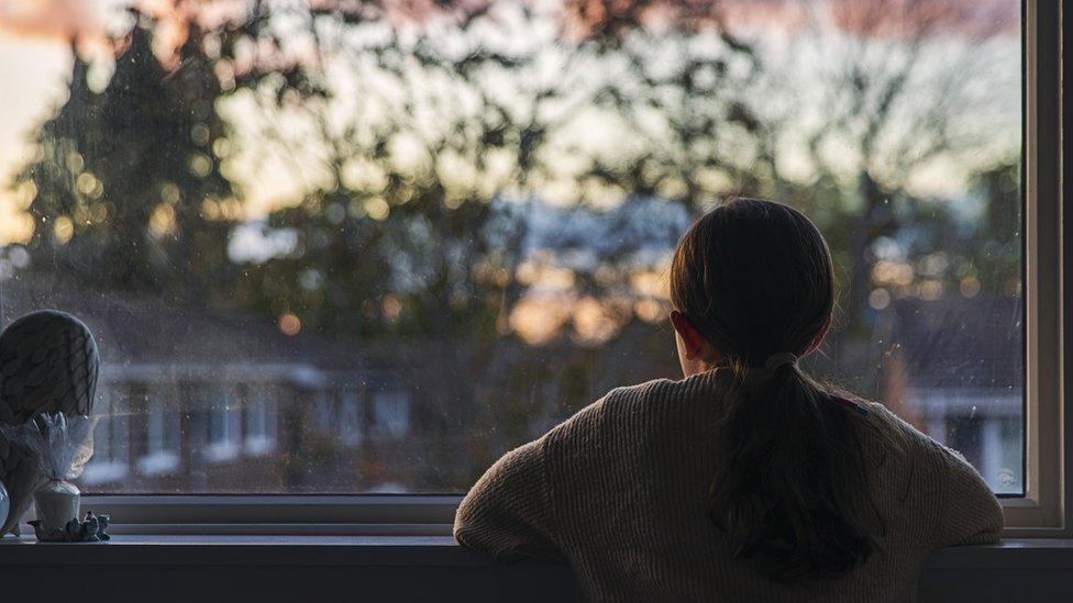 Child looking out of window