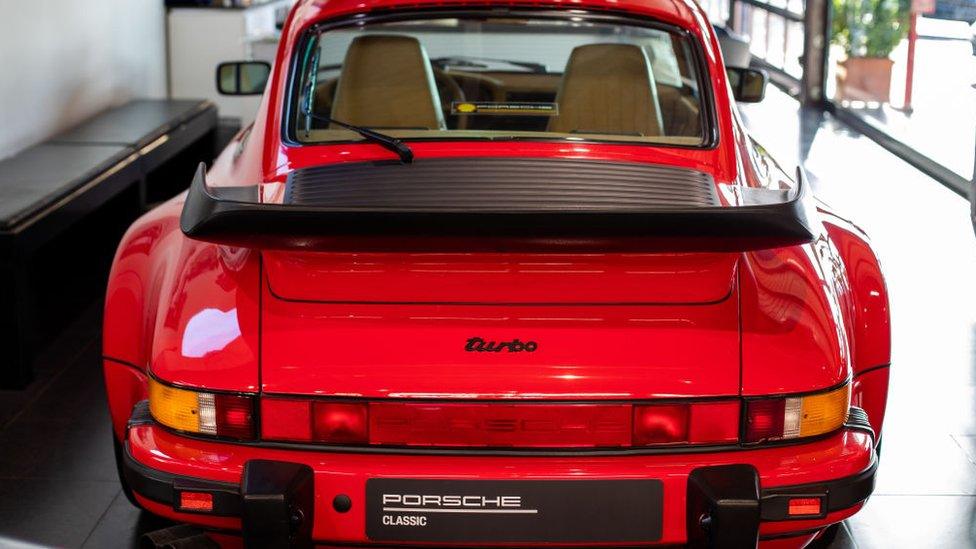 A Porsche 911 Turbo at a Porsche dealership.