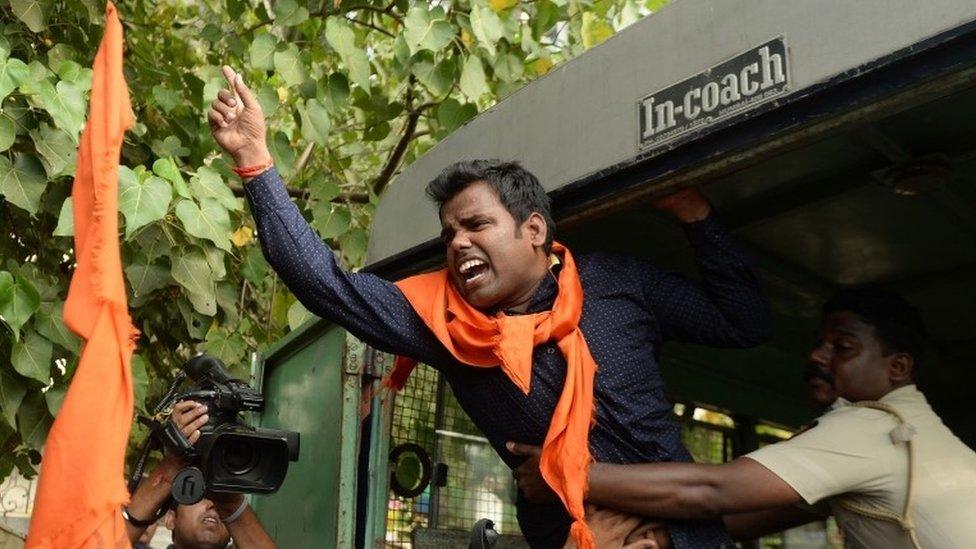 An Indian activist shouts slogans as he is detained by police outside the home of Bollywood actor Aamir Khan in Mumbai on November 24, 2015.