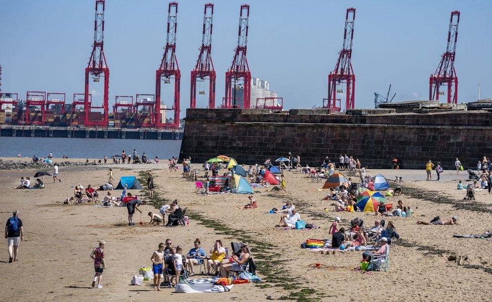 Sunbathers make the most of the mini heatwave in New Brighton, Wirral,