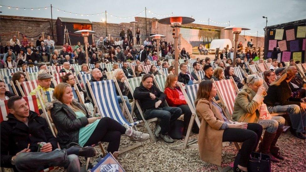 Crowds watching comedy evening at Dismaland