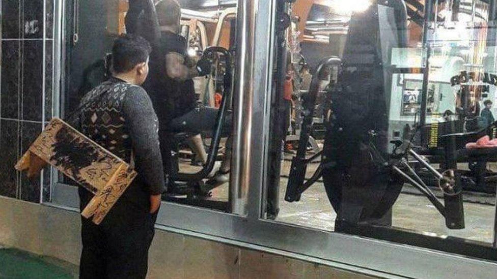 Mohammet Hussein staring through the window of a gym in Turkey