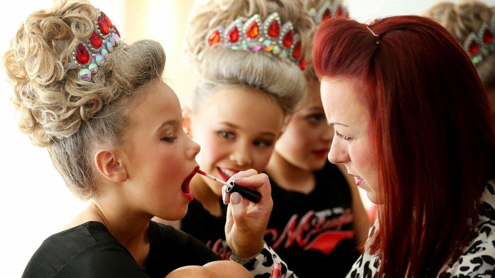 Competitors preparing their makeup