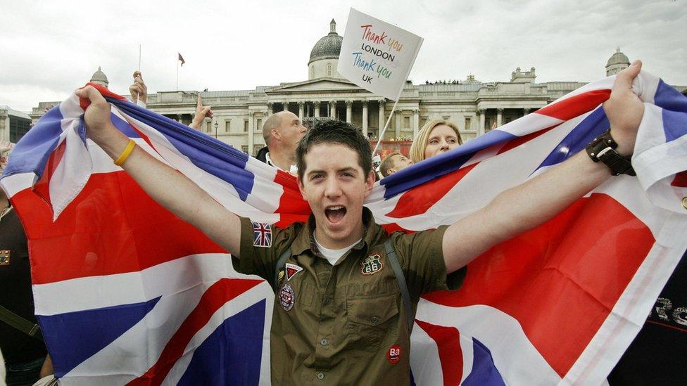 A Londoner celebrates with a Union Jack as the announcement is made that London will host the 2012 Olympic Games