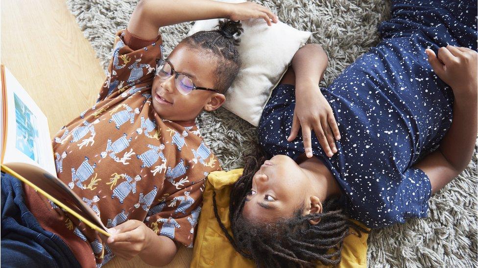 two boys on the floor reading