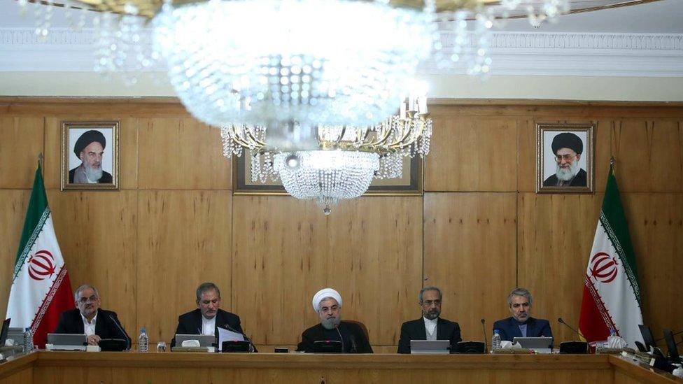 A handout picture provided by the office of Iranian President Hassan Rouhani shows him (C) meeting with members of his cabinet in Tehran on 9 November 2016