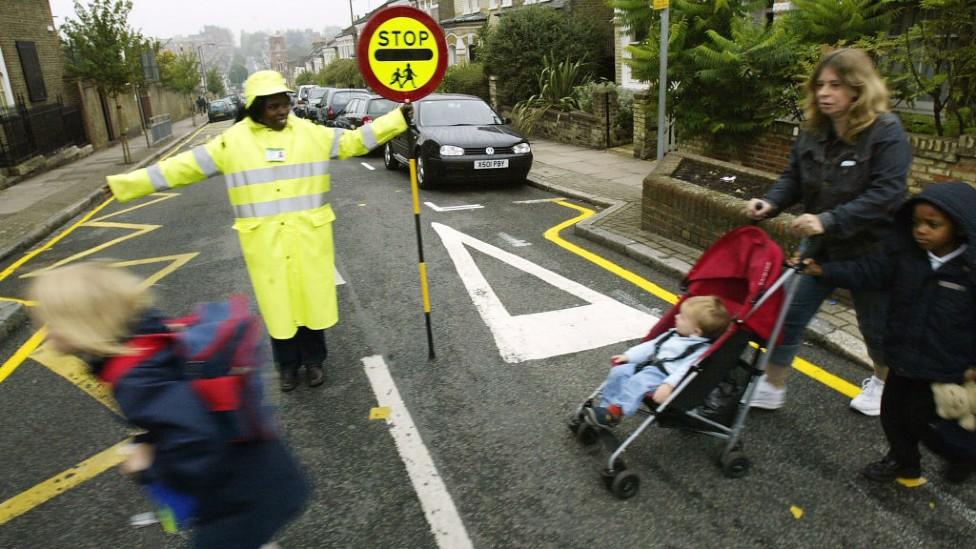 Children and adult crossing road