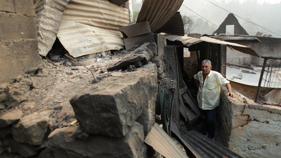 Avelino Viveiros studies his fire-damaged home at Curral dos Romeiros in Funchal, Madeira island, Portugal 10 August 2016