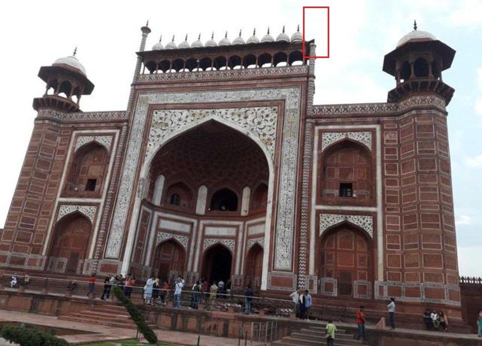 The royal gate of the Taj Mahal with the pillar on the right hand side damaged