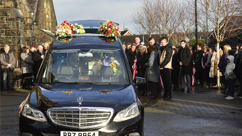 Coffin being unloaded from a hearse