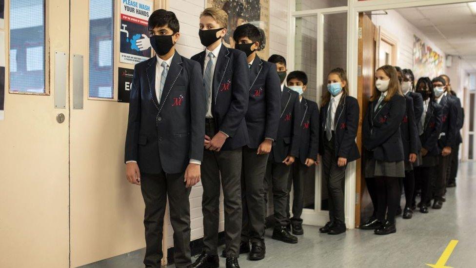 Pupils wear masks in school corridor