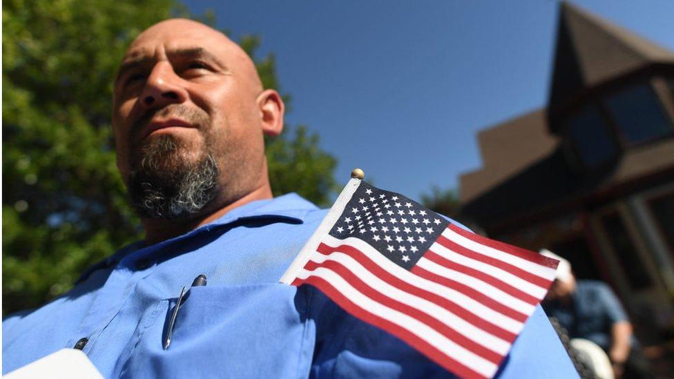 Man with American flag in his pocket during a naturalization ceremony