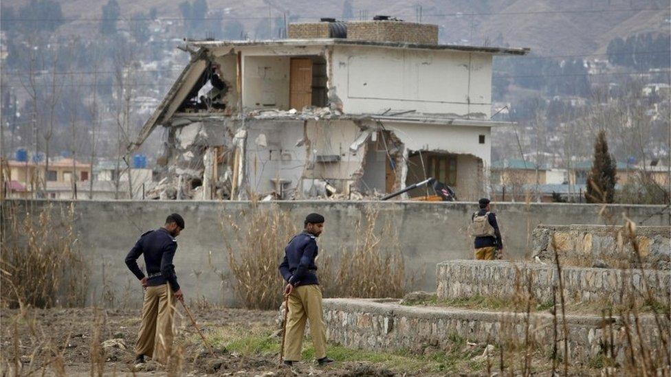 Policemen stand guard near the partially demolished compound where al Qaeda leader Osama bin Laden was killed by US special forces last May, in Abbottabad this February 26, 2012 file photo.