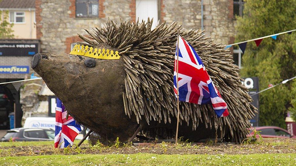 Hedgehog adorned with crown and flags