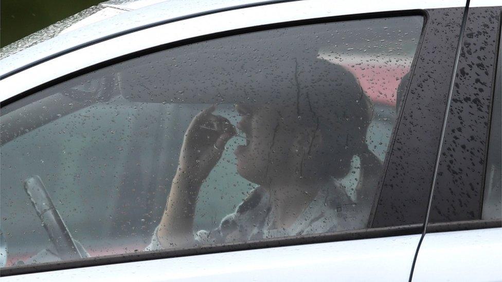 An unidentified key worker tests herself at one of a coronavirus drive-through centre