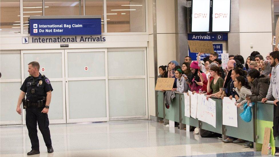 People gather to protest against the travel ban imposed by U.S. President Donald Trump's executive order, at Dallas/Fort Worth International Airport in Dallas