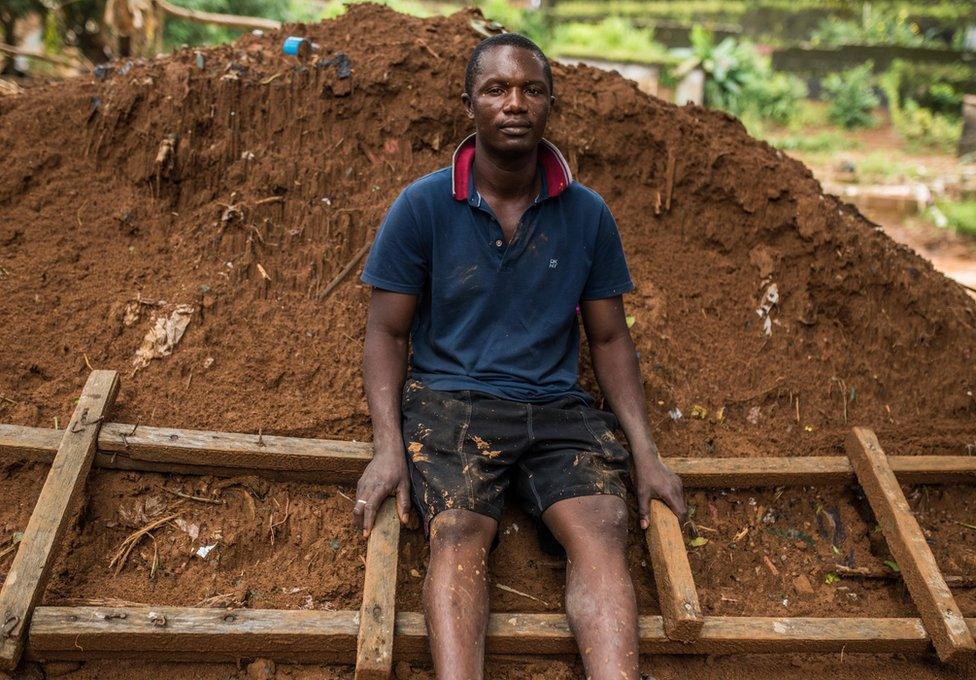 Abdul Mansaray sitting on the ladder that saved him and his family