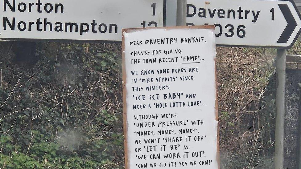 Council posts song lyric response to 'Daventry Banksie' signs - BBC News