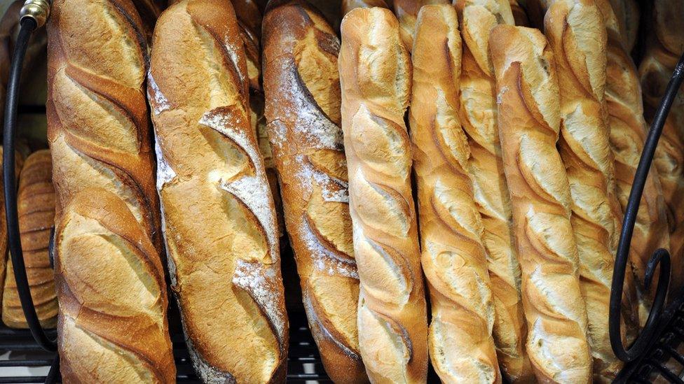 Baguettes and breads are on display in a bakery of Quimper on May 11, 2015, western of France.