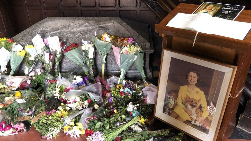 Flower tributes and a book of condolences at St Columb's Church of Ireland Cathedral