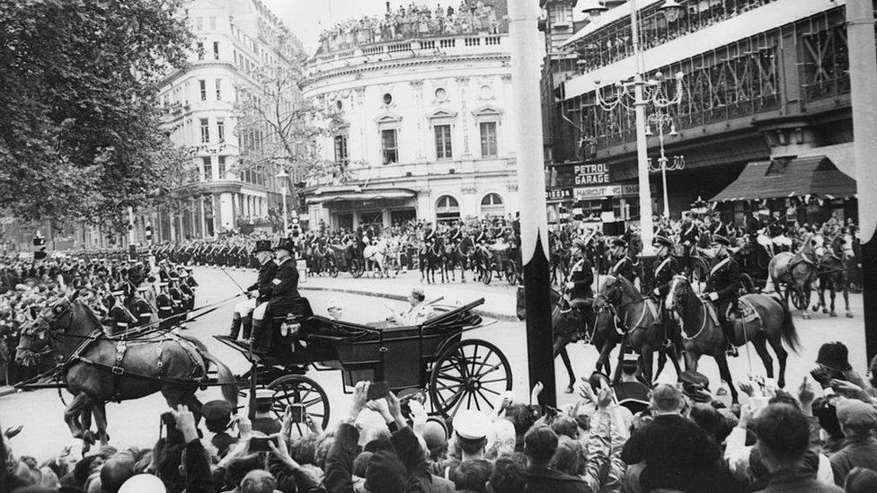 Queen Sālote Topou of Tonga riding past crowds of people along the Thames Embankment, on her way to the coronation of Queen Elizabeth II at Westminster Abbey, London, June 2nd 1953