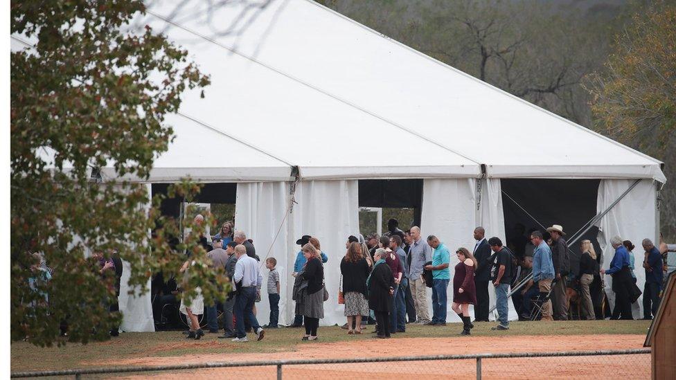 Worshipers attend service at the temporary First Baptist Church of Sutherland Springs on November 12, 2017 in Sutherland Springs, Texas. The service was held in a tent on the site of the town's baseball field.