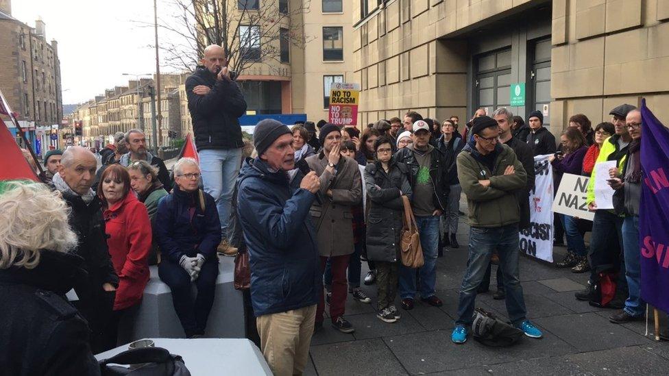 Around 100 protesters gathered outside the conference