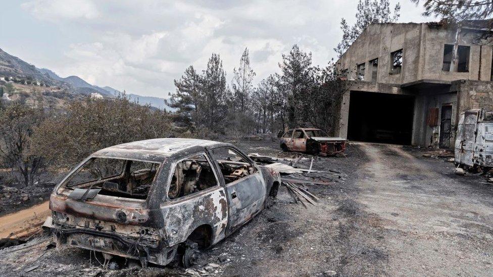 A destroyed house and car at a village on the southern slopes of the Troodos mountains